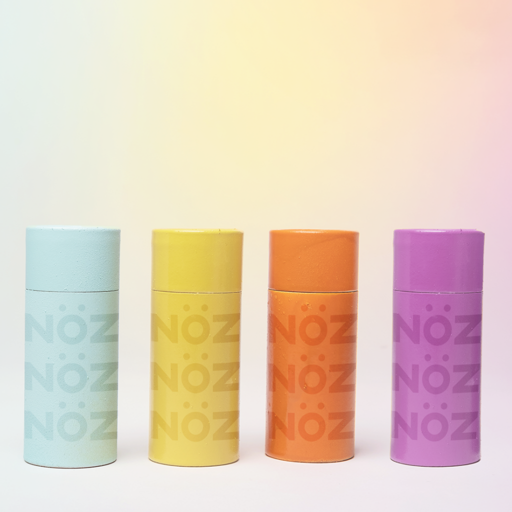 Nöz sunscreen featuring four color options, blue, yellow, orange, and purple