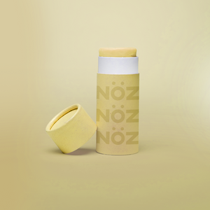 Nöz reef safe sunscreen shown in yellow with cap off to show product texture.